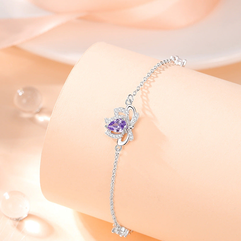 Sterling Silver Lotus and Bow Bracelet – Zircon Accents
