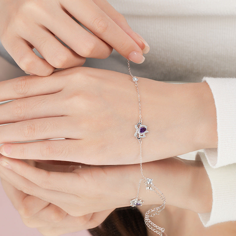 Sterling Silver Lotus and Bow Bracelet – Zircon Accents